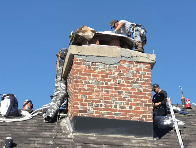 Cuyahoga Falls Chimney Sweep installing a custom chimney crown in Cuyahoga Falls, OH