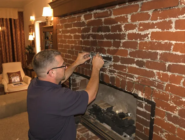 Cuyahoga Falls Chimney Sweep expert fixing a fireplace in Cuyahoga Falls, OH